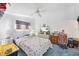 Bedroom with ceiling fan, window, and dresser at 3300 Loveland Blvd # 1504, Punta Gorda, FL 33980