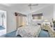 Bright bedroom featuring a comfortable bed, ceiling fan, and natural light at 3300 Loveland Blvd # 1504, Punta Gorda, FL 33980