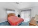 Bright bedroom with a comfortable bed, ceiling fan, and natural light at 3300 Loveland Blvd # 1504, Punta Gorda, FL 33980