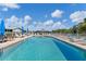 Refreshing community pool surrounded by lounge chairs, perfect for a relaxing day under the sun at 3300 Loveland Blvd # 1504, Punta Gorda, FL 33980