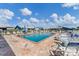 Relaxing community pool with lounge chairs and a manicured deck and lush landscaping around the perimeter at 3300 Loveland Blvd # 1504, Punta Gorda, FL 33980