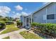 Exterior view featuring the entrance, landscaping, and screened porch at 3300 Loveland Blvd # 1504, Punta Gorda, FL 33980