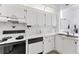Bright white kitchen featuring modern appliances and ample counter space at 3300 Loveland Blvd # 1504, Punta Gorda, FL 33980