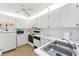 Bright white kitchen featuring modern appliances and ample counter space at 3300 Loveland Blvd # 1504, Punta Gorda, FL 33980
