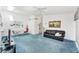 Spacious living room with a ceiling fan and blue carpet at 3300 Loveland Blvd # 1504, Punta Gorda, FL 33980
