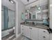 Beautiful bathroom with updated vanity, mirrors, lighting fixtures and a seamless glass shower at 335 Englewood Isles Pkwy # 55, Englewood, FL 34223