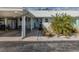 Inviting home exterior with carport, a well-maintained yard, and a covered entrance walkway at 335 Englewood Isles Pkwy # 55, Englewood, FL 34223