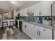 Modern kitchen boasting white cabinets, stainless appliances, and tiled backsplash, a chef's delight at 335 Englewood Isles Pkwy # 55, Englewood, FL 34223