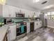 Charming kitchen featuring white cabinets, stainless steel appliances, and modern countertops at 335 Englewood Isles Pkwy # 55, Englewood, FL 34223