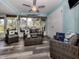 Cozy living room featuring beach decor, a ceiling fan, and an abundance of natural light at 335 Englewood Isles Pkwy # 55, Englewood, FL 34223