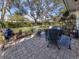 Relaxing patio with wicker chairs and a view of the lush, green backyard at 335 Englewood Isles Pkwy # 55, Englewood, FL 34223