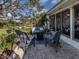 Charming patio with wicker furniture, brick pavers, and well maintained backyard at 335 Englewood Isles Pkwy # 55, Englewood, FL 34223