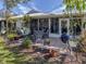 Relaxing outdoor patio area perfect for entertaining with seating, a grill, and lush landscaping at 335 Englewood Isles Pkwy # 55, Englewood, FL 34223