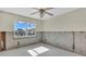 Well-lit room with a large window and visible concrete walls offers a bright space ready for customization at 833 White Cap Cir # 8, Venice, FL 34285