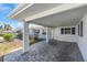 Spacious carport features a patterned brick floor and white pillars at 833 White Cap Cir # 8, Venice, FL 34285