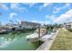 Waterfront property featuring boat dock, boat, lush landscaping, and idyllic water view at 833 White Cap Cir # 8, Venice, FL 34285