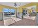 Bright and open living area with wood look tile flooring and sliding glass door to water view at 833 White Cap Cir # 8, Venice, FL 34285