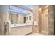 Well-lit bathroom with a double vanity, large mirror, and a step-in shower at 900 Paisley Ct # 1, Venice, FL 34293