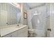 Well-lit bathroom with a single sink, vanity, and bathtub with shower at 900 Paisley Ct # 1, Venice, FL 34293