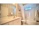 Well-lit bathroom featuring a vanity with storage, tub with shower, and a tiled floor at 900 Paisley Ct # 1, Venice, FL 34293
