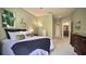 Comfortable bedroom with light green walls, a plush bed, and decorative accents at 900 Paisley Ct # 1, Venice, FL 34293