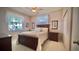 Bedroom features a ceiling fan, a large window, and dark wood furniture, perfect for rest at 900 Paisley Ct # 1, Venice, FL 34293