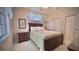 Bedroom with soft lighting, dark wood furniture, and a double closet at 900 Paisley Ct # 1, Venice, FL 34293