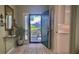 Inviting entryway with open door leading to patio, rug, and a view of the kitchen at 900 Paisley Ct # 1, Venice, FL 34293