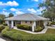 Beautiful home with lush landscaping, mature trees, and well-maintained lawn and tiled roof at 900 Paisley Ct # 1, Venice, FL 34293