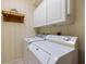 Efficient laundry room equipped with modern washer, dryer, and white cabinetry for ample storage at 900 Paisley Ct # 1, Venice, FL 34293