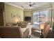 Inviting living room with ceiling fan, with sliding door access to a screened-in patio at 900 Paisley Ct # 1, Venice, FL 34293