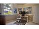Home office featuring a modern desk, ergonomic chair, and stylish artwork at 900 Paisley Ct # 1, Venice, FL 34293