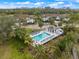Aerial view of a community pool with ample seating, a gazebo, and lush landscaping at the Plantation Golf & Country Club at 900 Paisley Ct # 1, Venice, FL 34293
