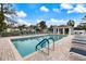 Community pool and deck area with a covered sitting area and chairs at 900 Paisley Ct # 1, Venice, FL 34293