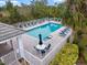 Relaxing community pool and deck area with several lounge chairs and table with seating at 900 Paisley Ct # 1, Venice, FL 34293