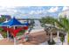 Aerial view of a community area with dining and entertainment near a waterfront at 11571 Gleaming Ter, Venice, FL 34293