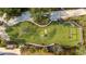 Aerial view of a recreational area featuring a playground, climbing structure, and grassy areas at 11571 Gleaming Ter, Venice, FL 34293