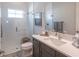 Modern bathroom featuring a glass-enclosed shower, single sink vanity, and neutral color scheme at 11571 Gleaming Ter, Venice, FL 34293