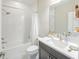Well-lit bathroom features a shower-tub combo and a single sink vanity with modern fixtures at 11571 Gleaming Ter, Venice, FL 34293