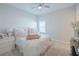 Comfortable bedroom with plush bedding, a ceiling fan, and a view of a bright window at 11571 Gleaming Ter, Venice, FL 34293