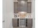 Elegant butler's pantry features custom cabinets, a wine fridge, and stylish countertop, perfect for entertaining at 11571 Gleaming Ter, Venice, FL 34293