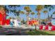 A community gathering space with food vendors and seating surrounded by lush landscaping and palm trees at 11571 Gleaming Ter, Venice, FL 34293