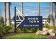 Downtown Wellen Park sign, a vibrant community, welcomes with lush landscaping and string lights at 11571 Gleaming Ter, Venice, FL 34293