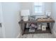 Stylish entryway table with decorative items and warm lighting from a table lamp at 11571 Gleaming Ter, Venice, FL 34293