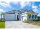 Beautiful single Gathering home featuring a paver driveway and 3-car garage at 11571 Gleaming Ter, Venice, FL 34293