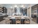 Modern kitchen featuring a center island with seating, stainless steel appliances, and ample storage at 11571 Gleaming Ter, Venice, FL 34293