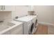 Well-lit laundry room with a sink, washer and dryer, and ample counter space at 11571 Gleaming Ter, Venice, FL 34293