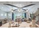 Open-concept living space with modern lighting and large windows offering scenic views and access to outdoor space at 11571 Gleaming Ter, Venice, FL 34293