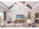 Inviting living room with wood beam ceiling, plush furniture, and access to the pool at 11571 Gleaming Ter, Venice, FL 34293