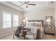 Comfortable main bedroom featuring tray ceiling, neutral colors, and ample natural light at 11571 Gleaming Ter, Venice, FL 34293